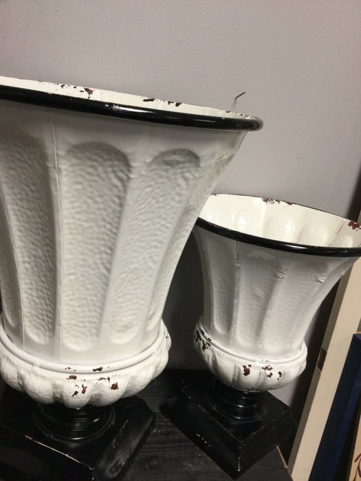 White and black metal planter urns